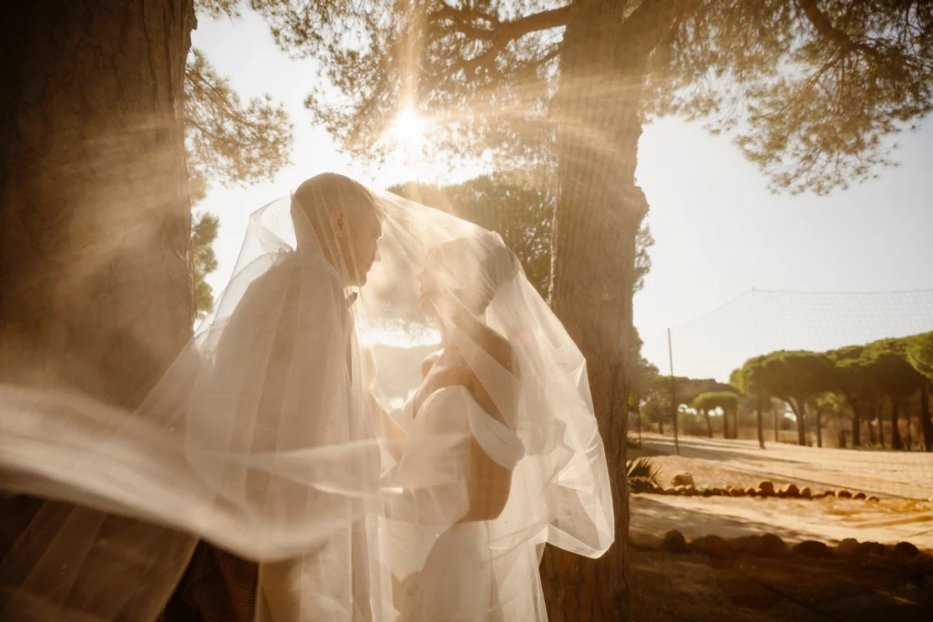 bride-and-groom-under-veil-with-sunset-light-algarve