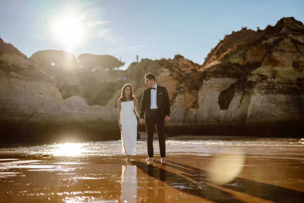 couple-walking-barefoot-on-algarve-beach-at-sunset1