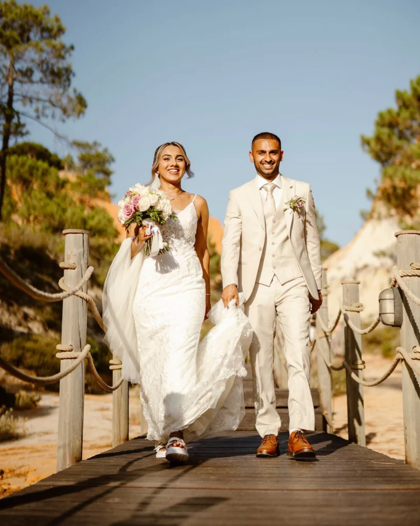 wedding-couple-walking-on-boardwalk-algarve-beach